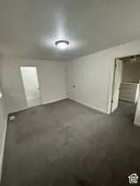 Recessed ceiling light fixture, neutral wall color, and gray carpet flooring