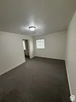 Recessed window with white trim, wall-to-wall carpeting, and a flush mount ceiling light