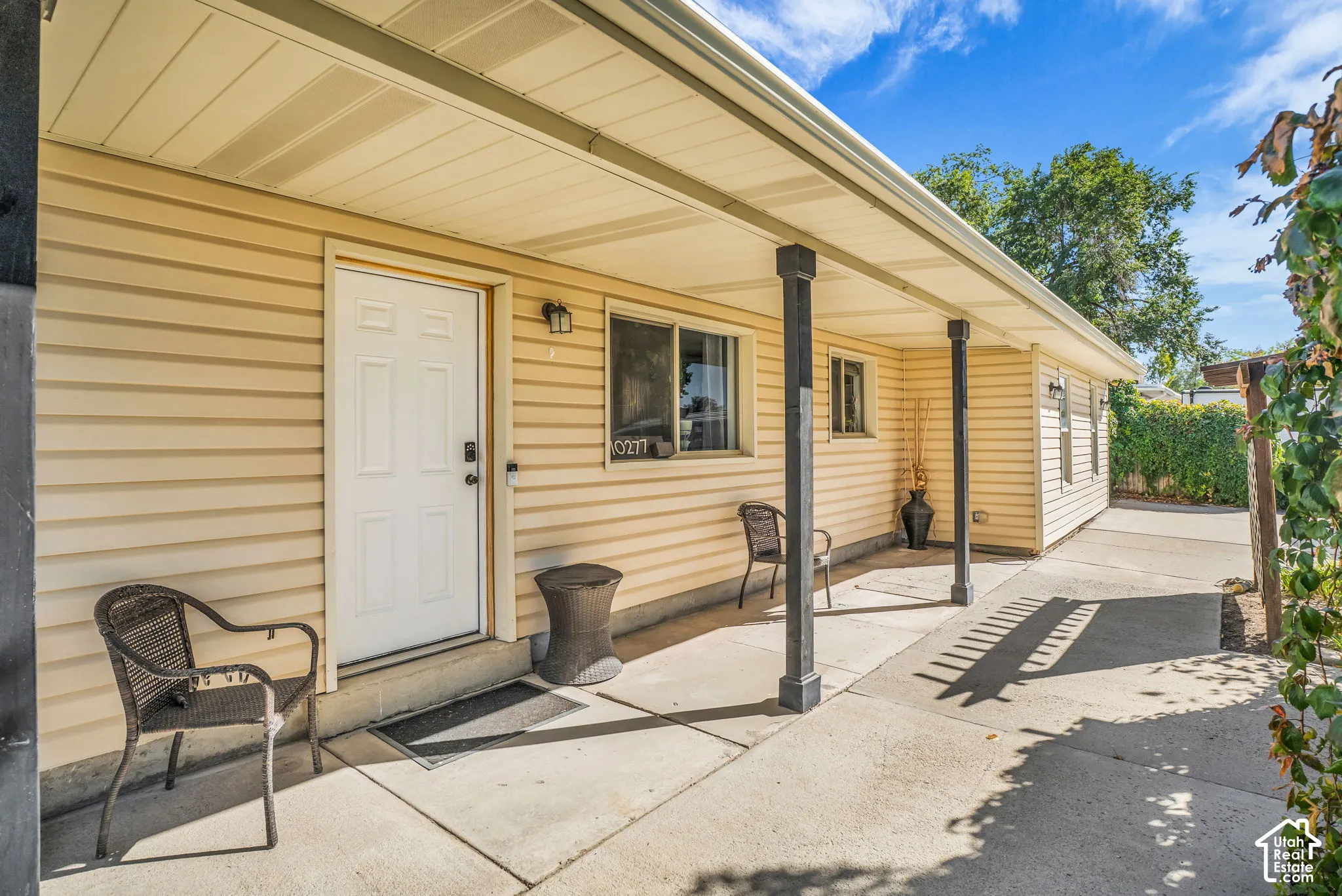 Covered porch with concrete flooring and light-colored siding