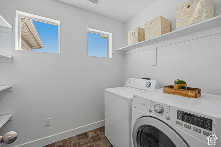 White walls, wood-finish flooring, and white floating shelves