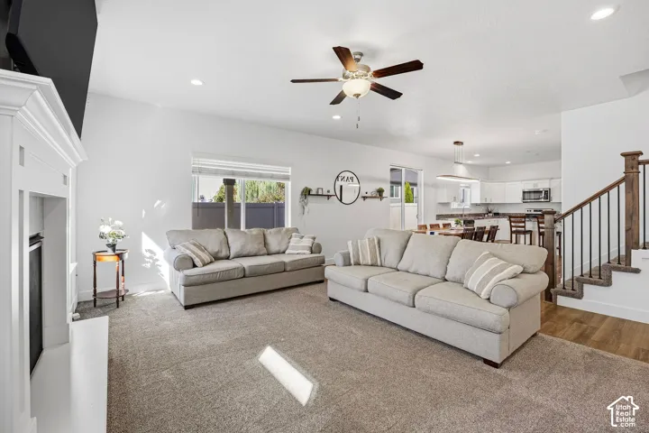 Living area featuring a white mantel, recessed lighting, and a ceiling fan