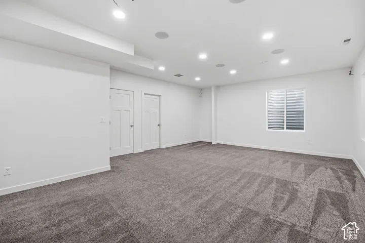 Recessed lighting, wall-to-wall carpeting, two panel doors, window with horizontal blinds, and ceiling-mounted speakers