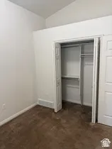 Brown carpeting with white walls and a bi-fold closet