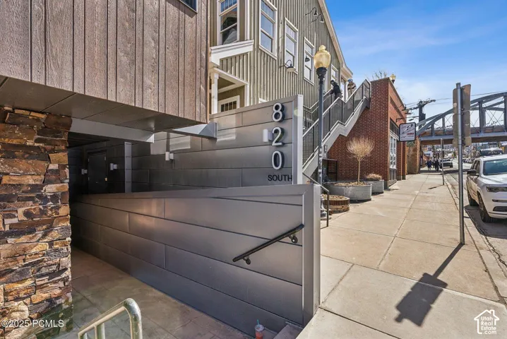 Exterior featuring wood-finish siding, stone accents, and metal paneling