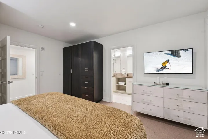 Recessed lighting, wood-finish flooring, a built-in wardrobe with varied storage, and two entryways