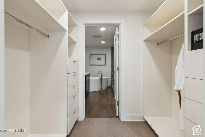 Custom closet system featuring shelving, hanging rods, and built-in drawers
