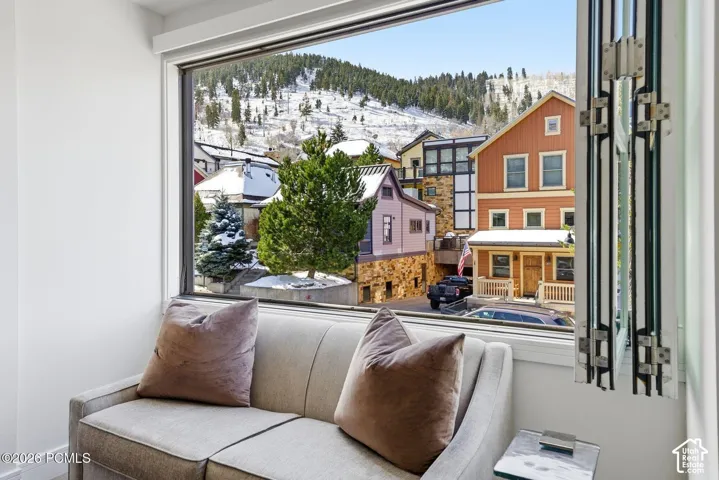 Expansive picture window with mountain and neighborhood scenery
