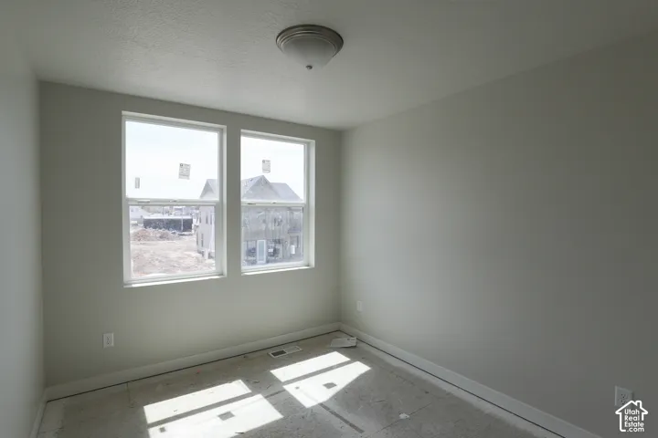 Two single-hung windows with white trim, light gray walls, and a flush mount ceiling light fixture