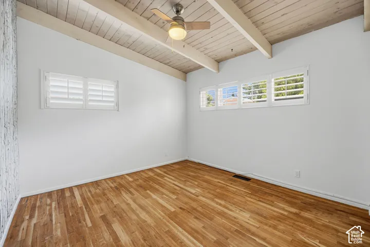 Wood-finish flooring with a white textured accent wall