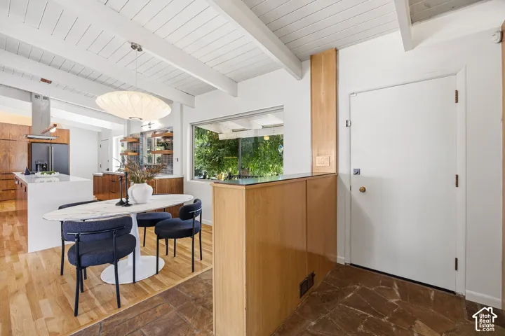 Exposed beam ceiling, clerestory window, wood-finish flooring, stone tile flooring, built-in cabinetry
