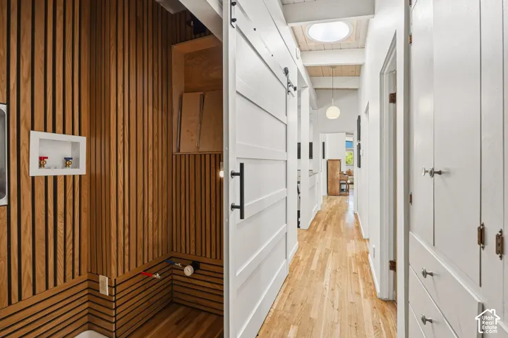 Wood-finish flooring throughout, white paneled doors, and a skylight