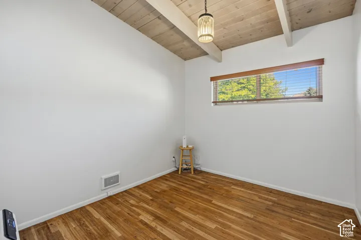 Vaulted wood-paneled ceiling with exposed beams