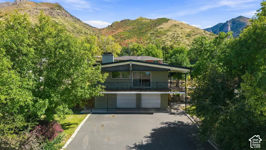 Two-story property with a low-slope roofline and an upper-level balcony