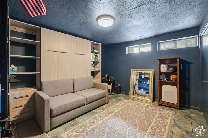 Built-in shelving units with integrated drawers, wood-finish wall paneling, and a tiled floor