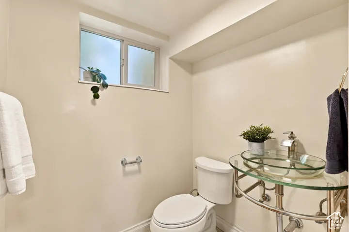 Frosted window, glass vessel sink, chrome fixtures, and built-in shelving