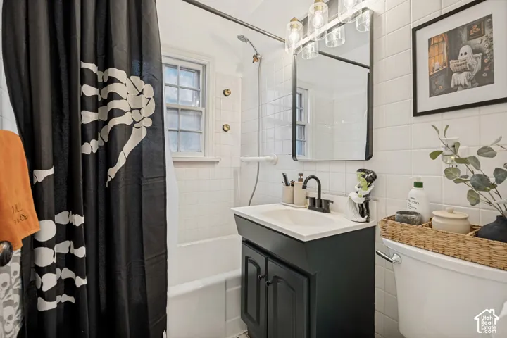 White tiled walls with a contrasting black vanity