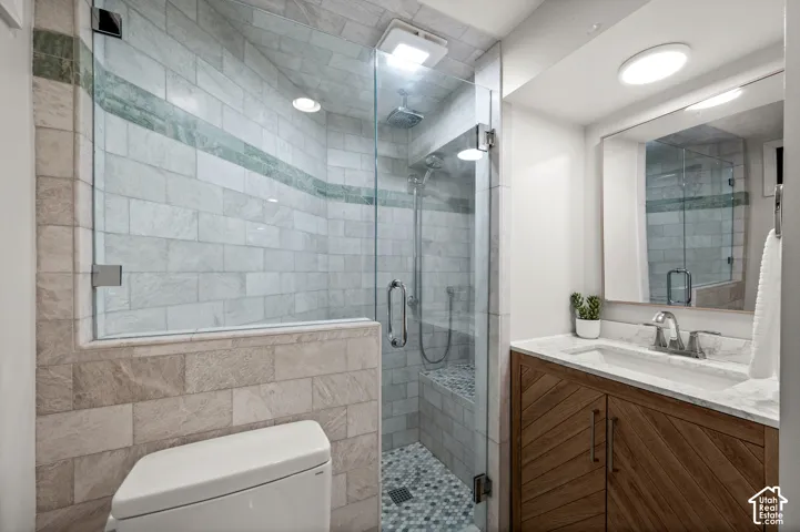 Glass-enclosed shower with a built-in bench