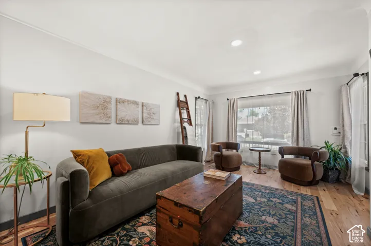 Wood-finish flooring, recessed lighting, and crown molding