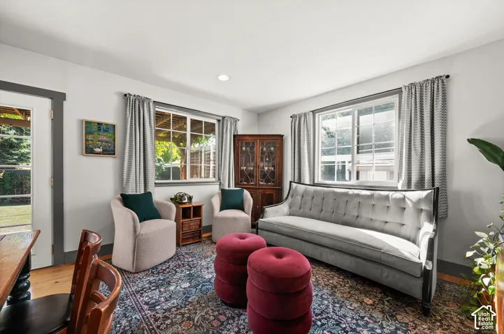 Recessed lighting, wood-finish flooring, and multiple windows with trim