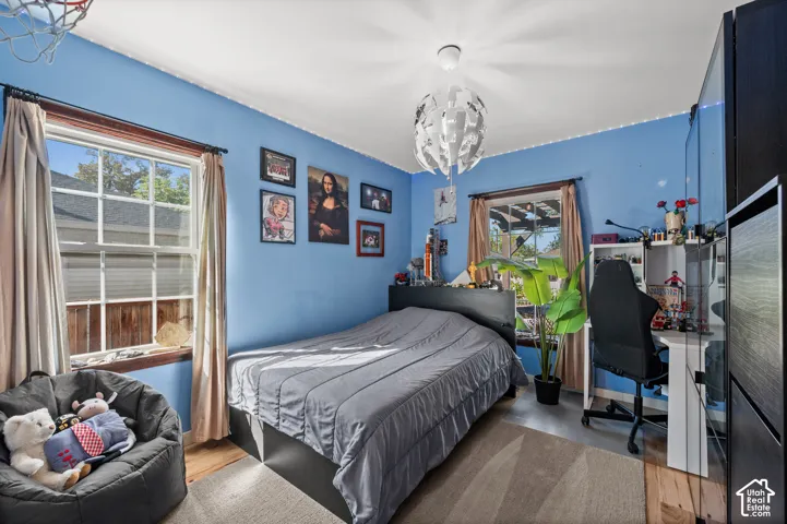 Hardwood-style flooring, a built-in desk, and a window with natural light