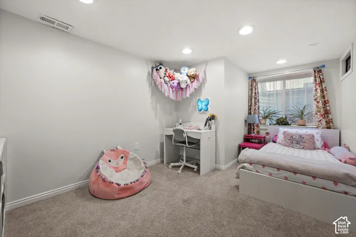 Recessed ceiling lighting, light-toned wall paint, white trim, carpet flooring, and a window with blinds