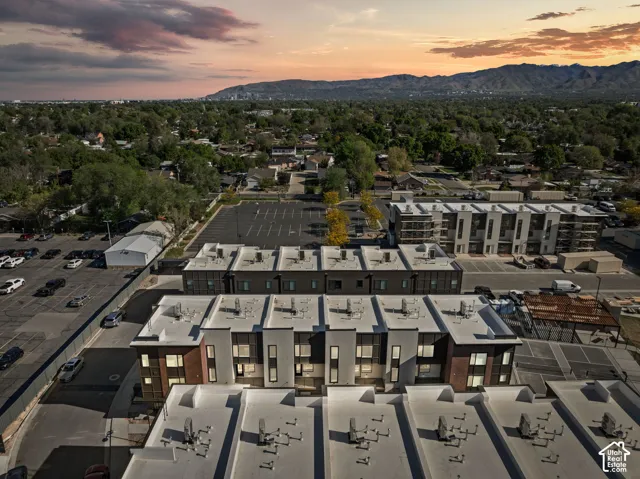 Modern multi-story buildings featuring varied facades, flat roofs, and integrated window designs