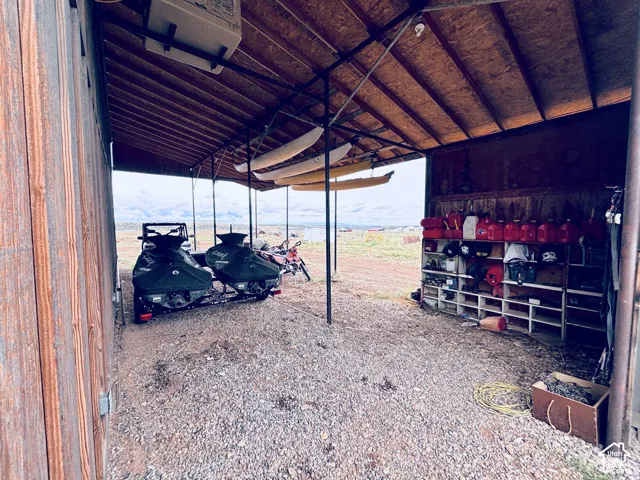 Covered parking area on side of Barn structure.
