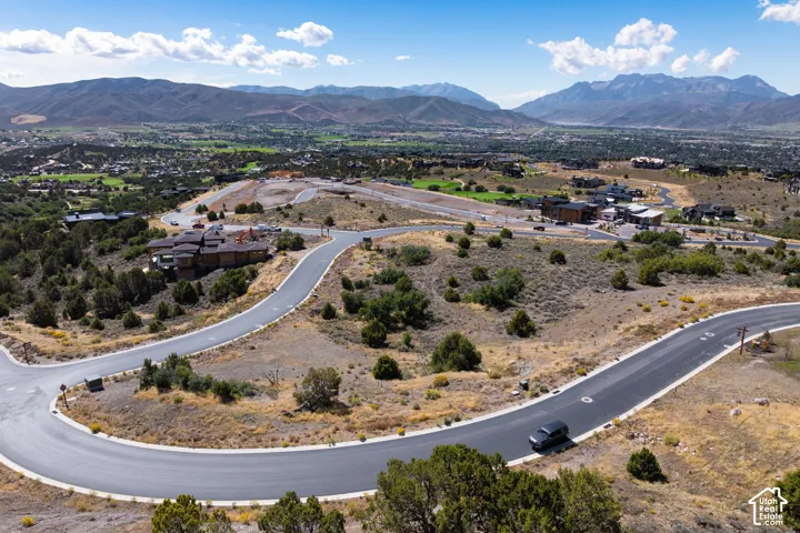 Mountainous terrain with paved roads and scattered residential structures