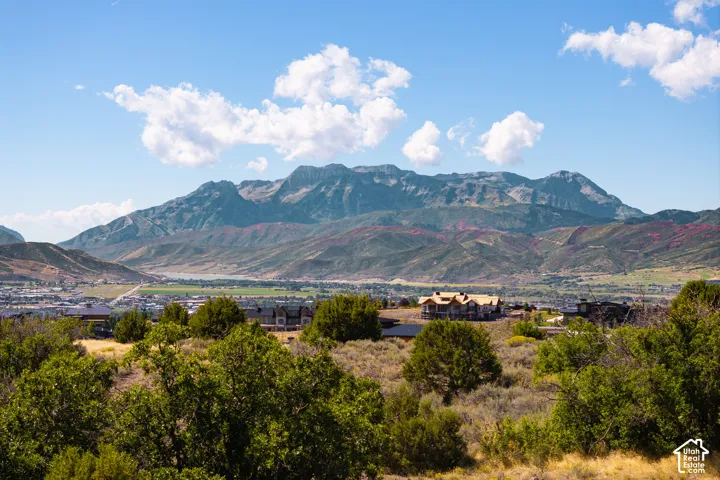 Expansive mountain backdrop with scattered clouds