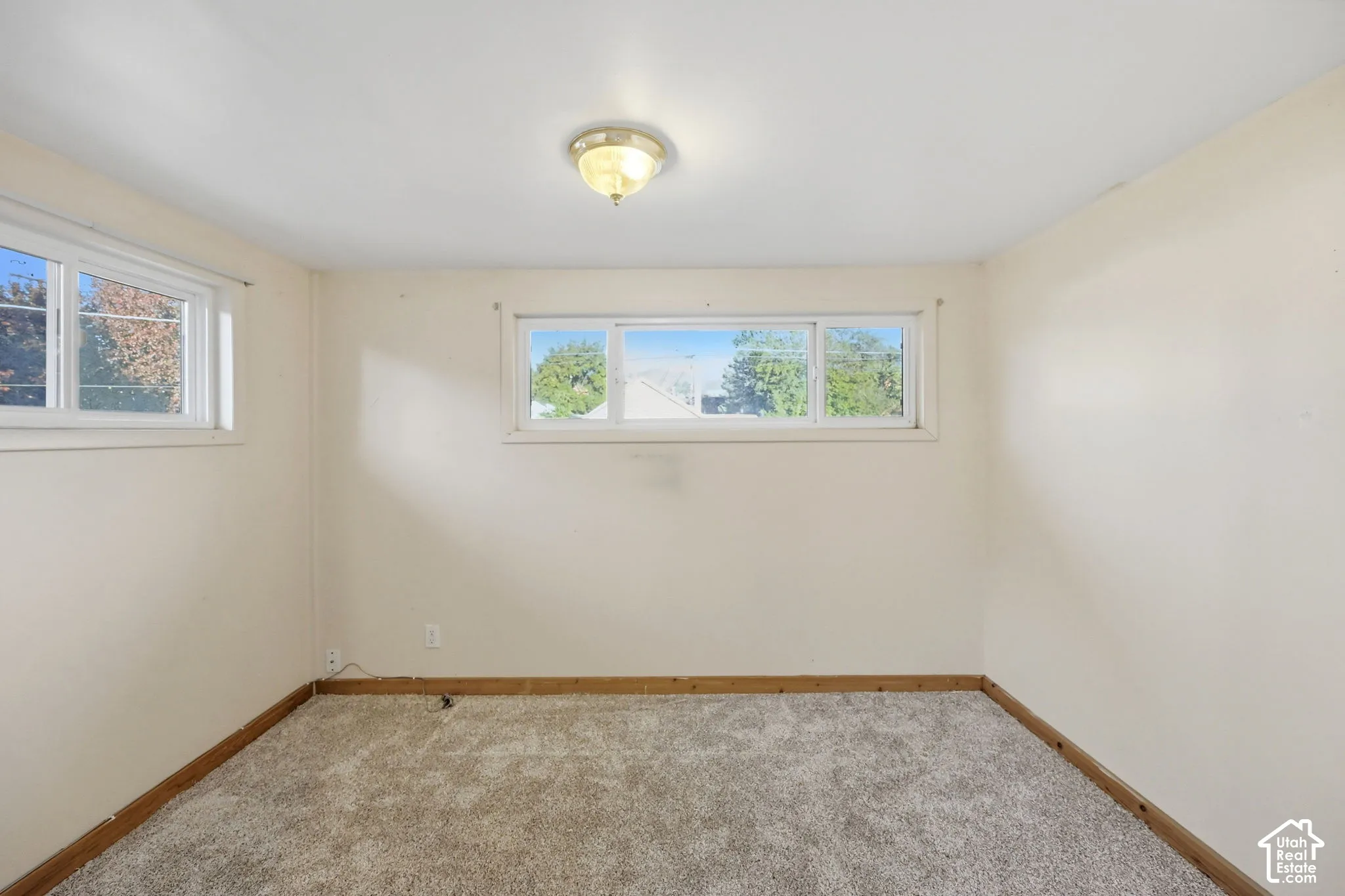 Neutral wall tones, recessed lighting fixture, carpeted flooring, and multiple windows