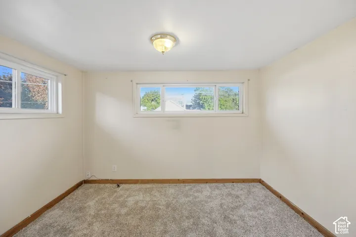 Neutral wall tones, recessed lighting fixture, carpeted flooring, and multiple windows