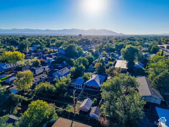 Expansive neighborhood with mature trees and visible mountain range