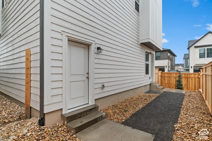 White horizontal siding exterior with a concrete stoop