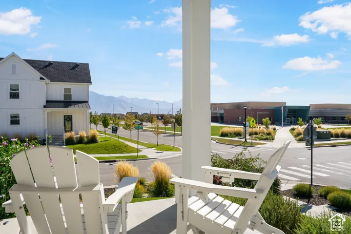 Covered front porch with concrete flooring and mountain backdrop