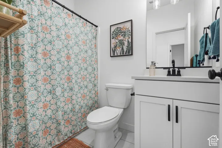 White vanity with matte black hardware, white countertop, and integrated sink