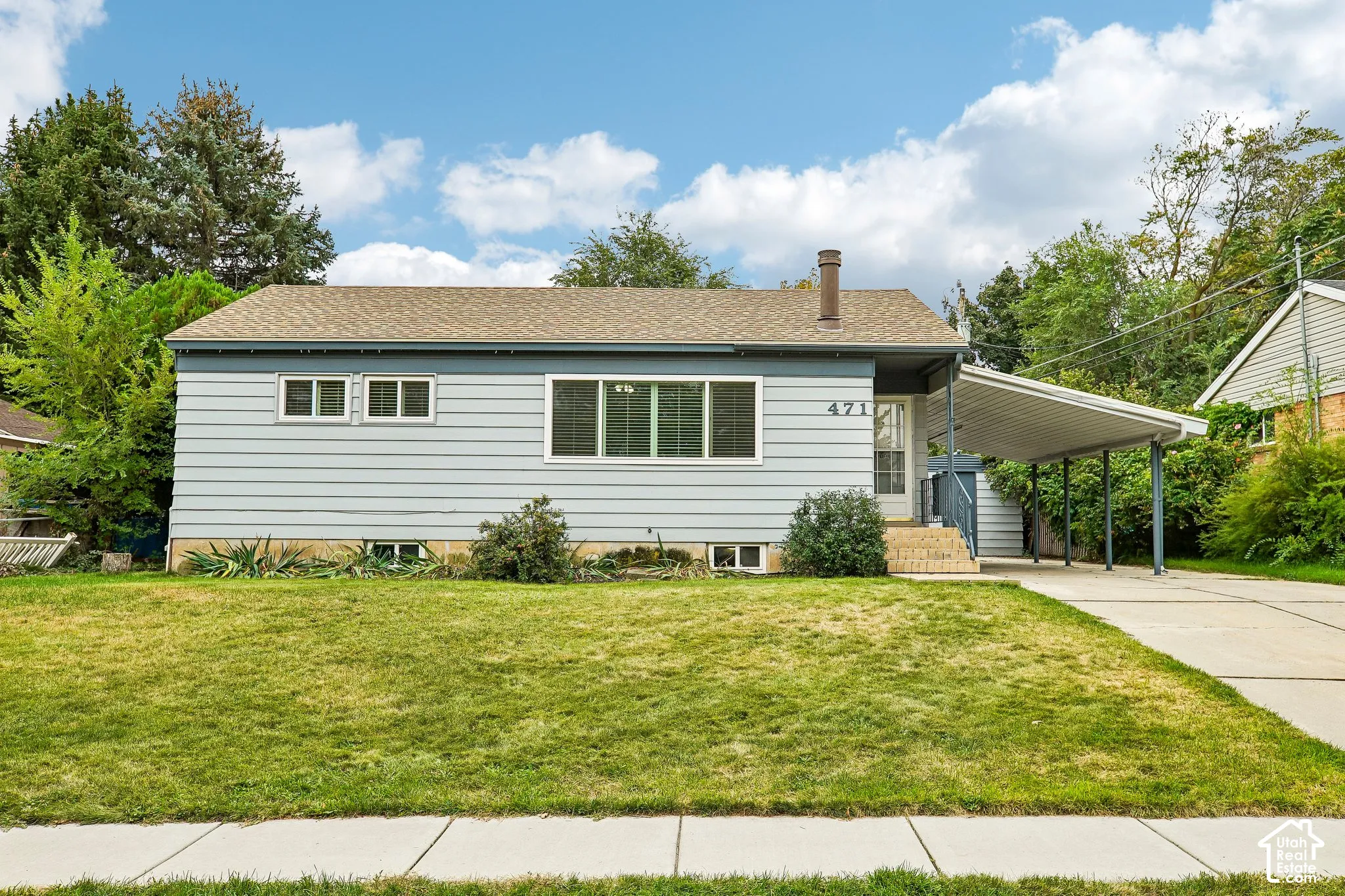 Light blue siding exterior with a brown shingle roof