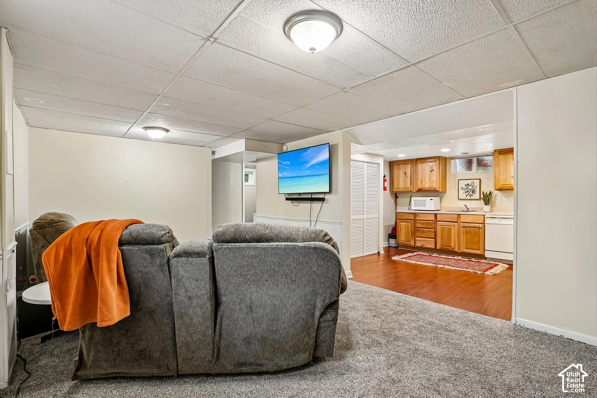 Carpeted living area with recessed lighting