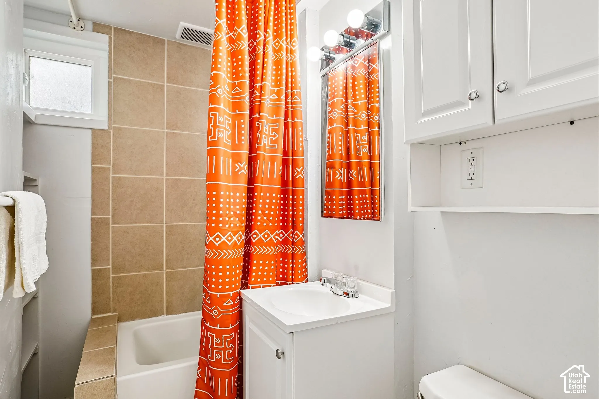 White vanity with an integrated sink and chrome faucet