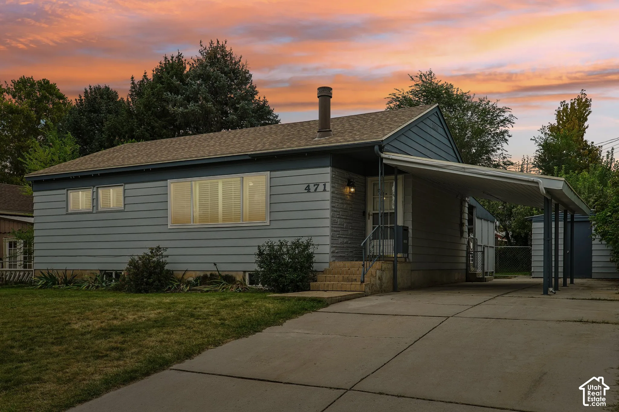Exterior featuring a carport, concrete driveway, and a shingled roof