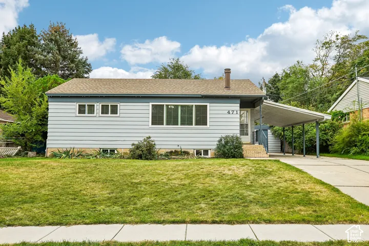 Light blue siding exterior with a brown shingle roof