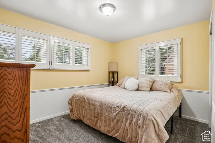 White plantation shutters, two-tone wall treatment, and recessed lighting
