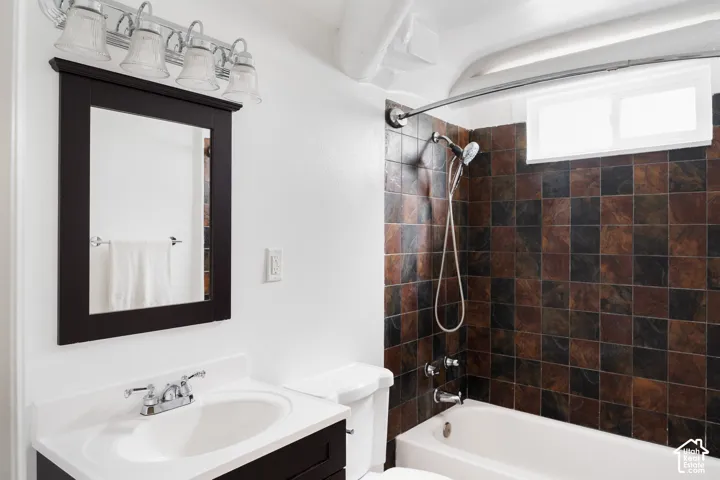 Vanity with integrated sink, chrome faucet, and framed mirror