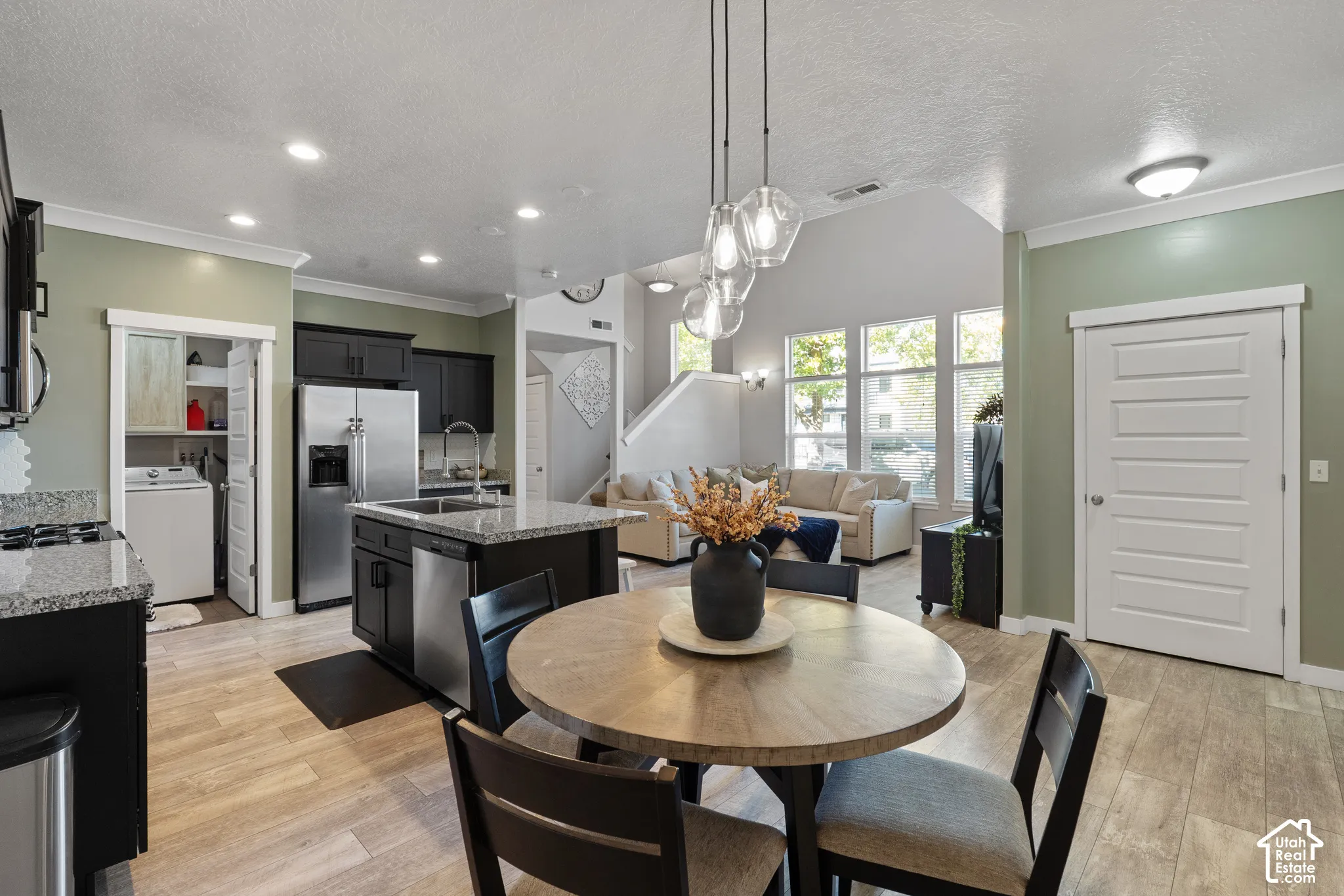 Kitchen featuring dark wood-finish cabinetry, stainless steel appliances, and granite countertops