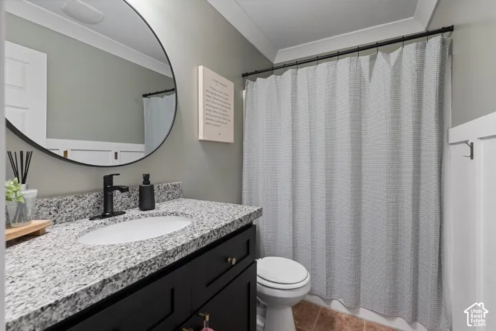 Bathroom vanity with a dark wood-finish cabinet and a speckled stone countertop