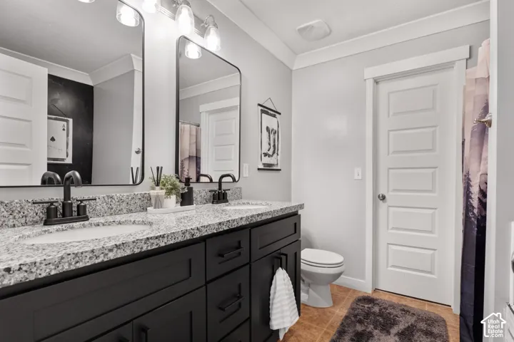 Dual vanity with a stone countertop, under-mount sinks, and matte black fixtures