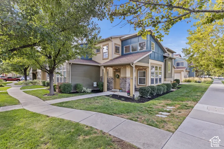 Multi-story exterior with varied siding, an inviting covered front porch, and stone accents