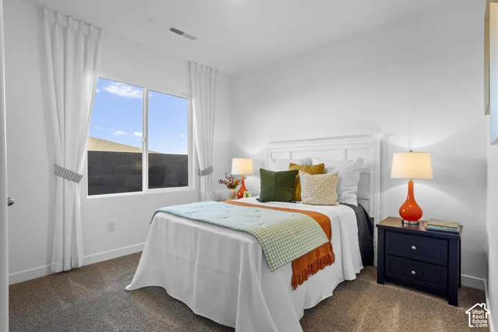 White paneled headboard, dual-pane window, wall-to-wall carpeting, and white walls