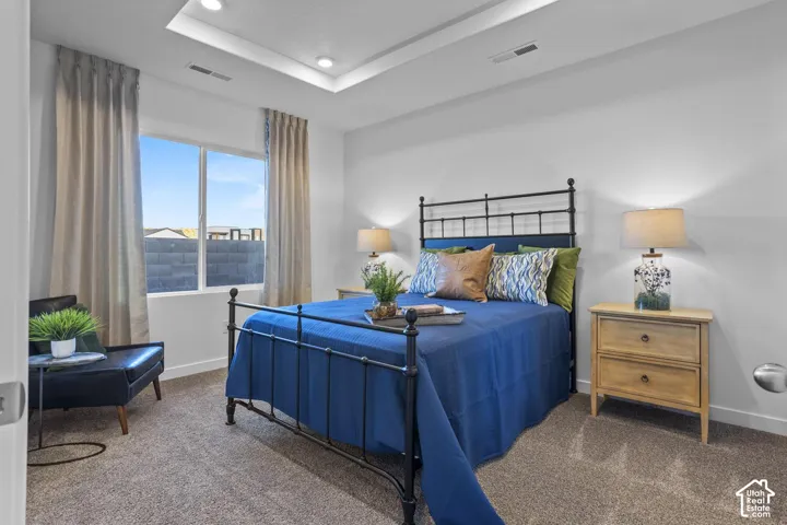 Recessed lighting and a tray ceiling accent the room