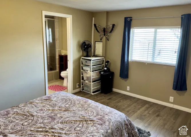 Wood-finish flooring throughout, neutral wall paint, and a window with blinds