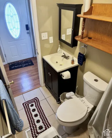 Bathroom with a dark wood-finish vanity, white countertop, and a wall-mounted medicine cabinet